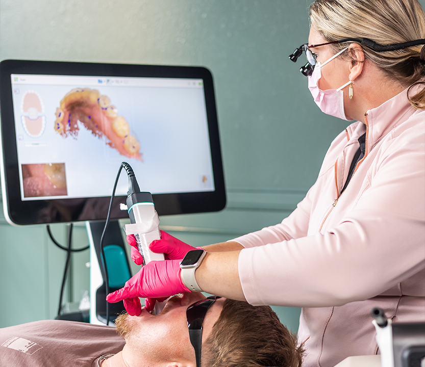Dentist capturing digital scans of a patient's teeth