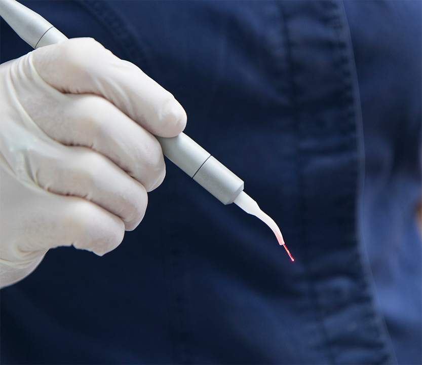 Dentist holding a laser pen