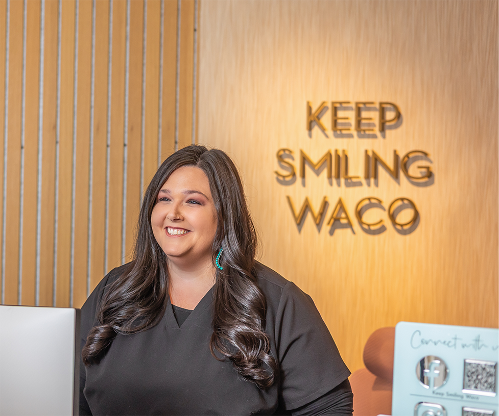 Dental team member smiling at a patient