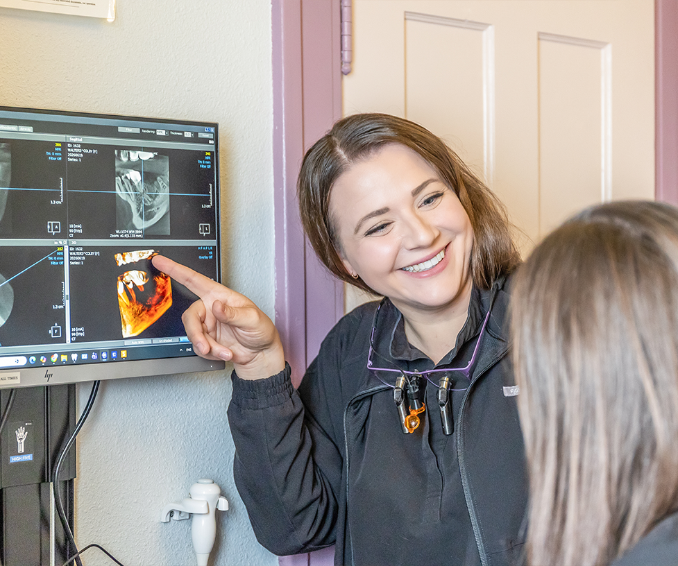 Dentist showing a patient several x-rays of their teeth and jaws