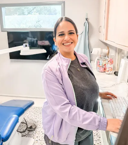 Smiling dental team member at a computer