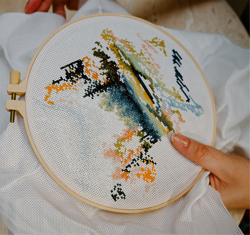 Person doing needlepointing work