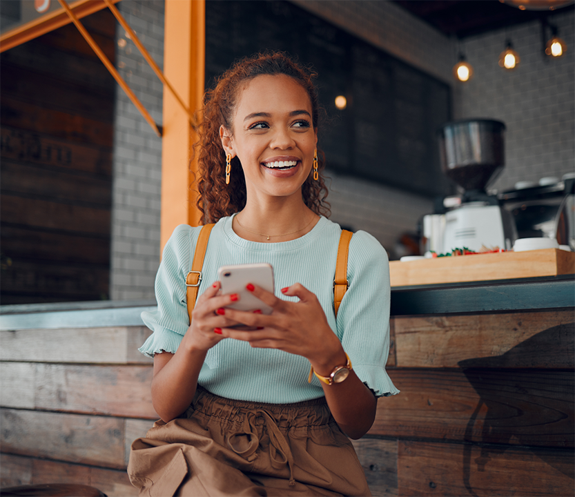 Smiling woman holding her phone