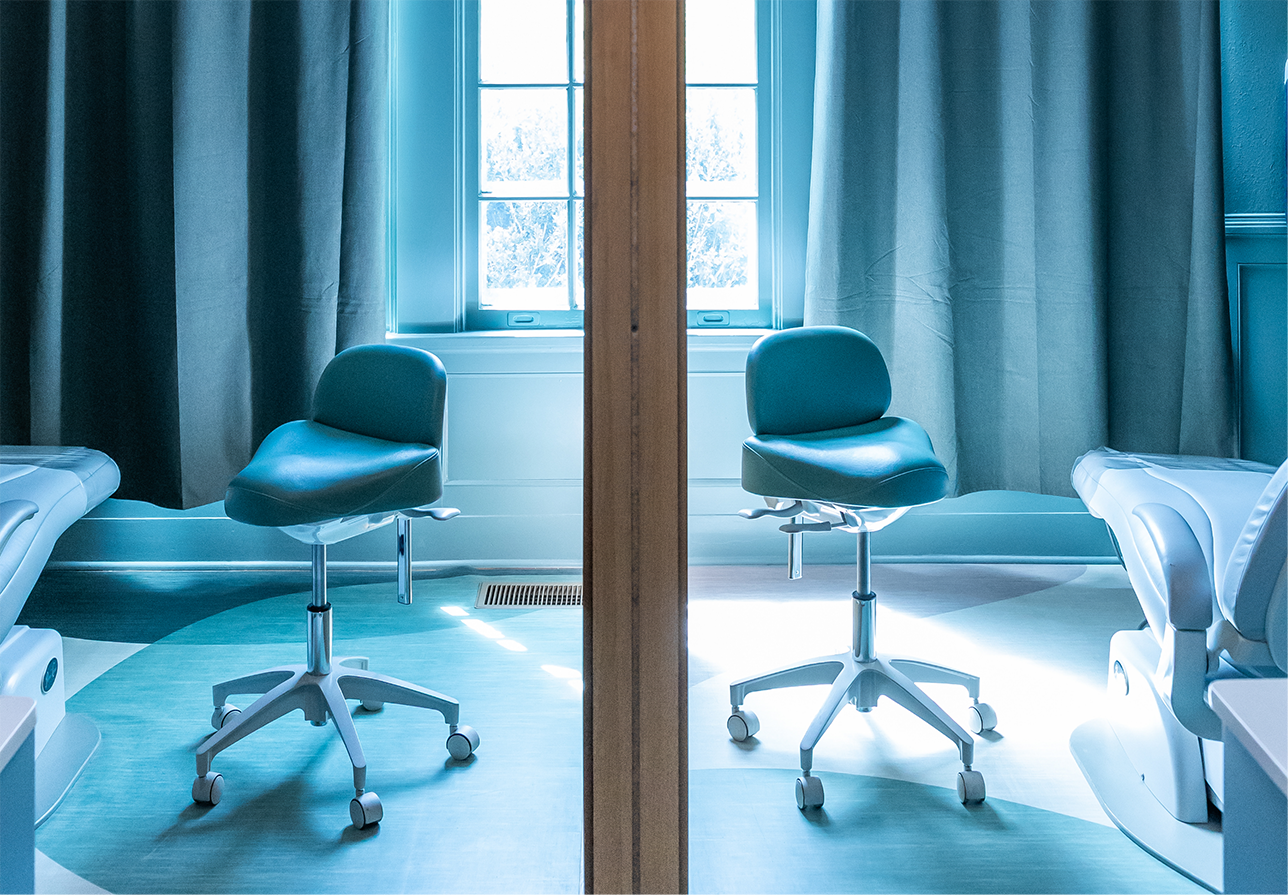 Blue chair connected to wheels in a dental exam room