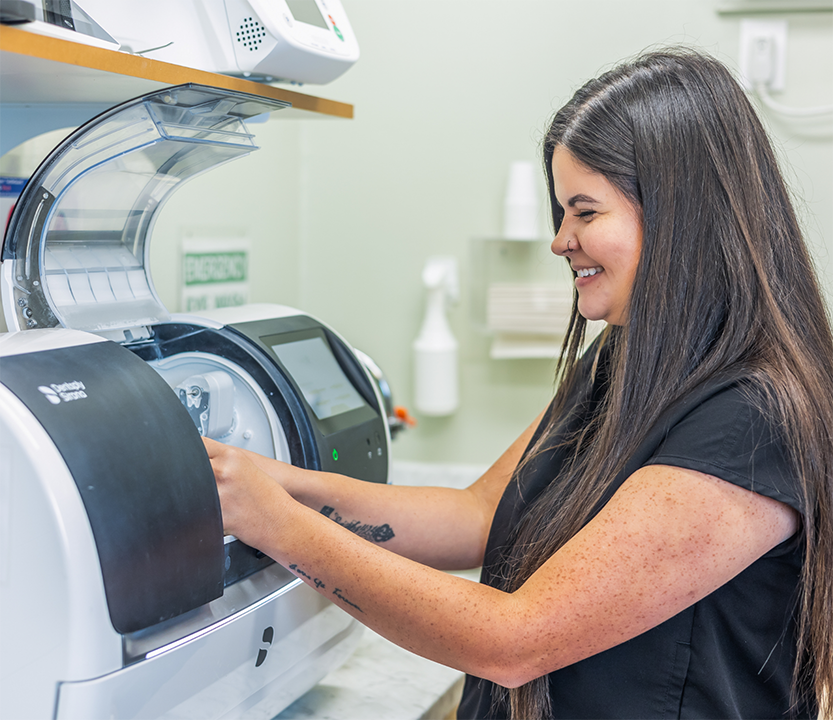 Dental professional handling a CEREC machine