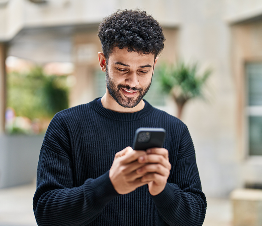 Young man typing on his phone