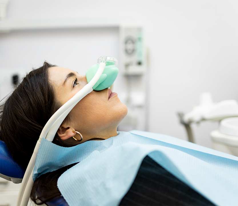 Dental patient with a nitrous oxide mask on her nose