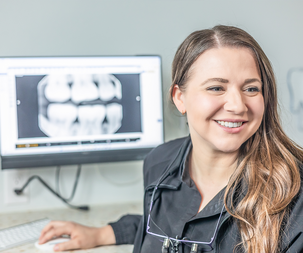 Dentist smiling while listening to a patient